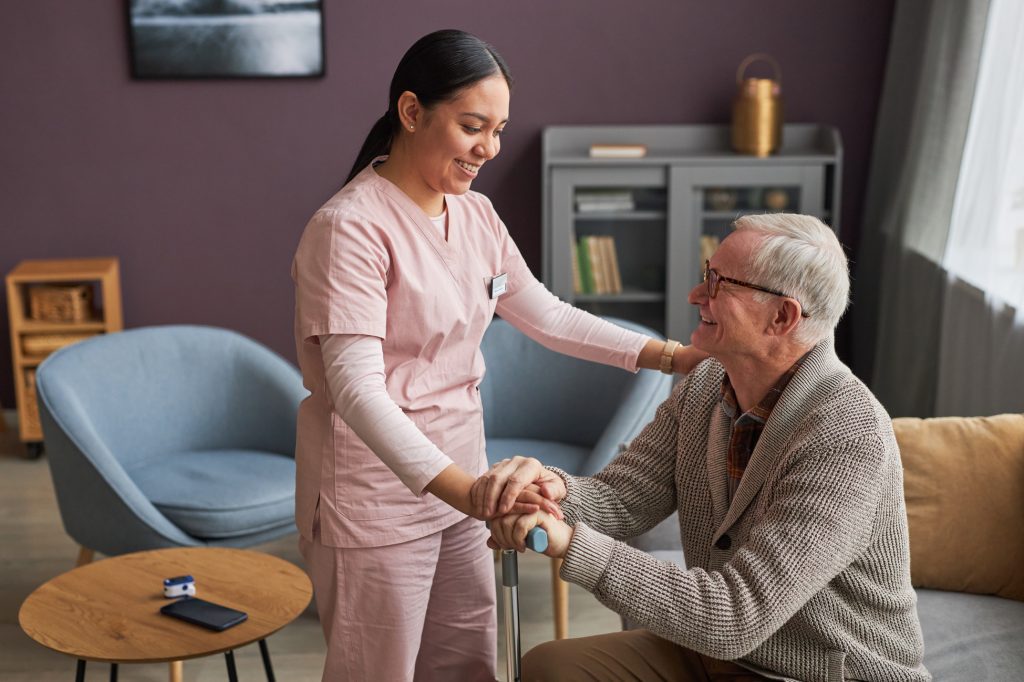 Respite care with a caregiver supporting a senior man.