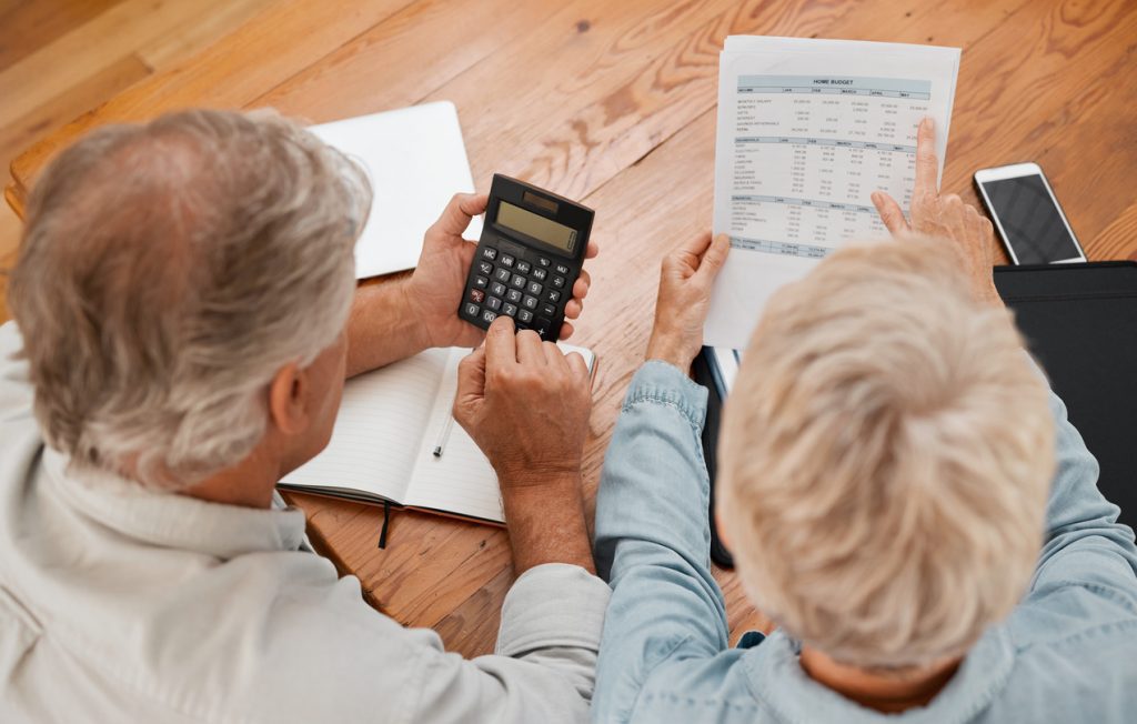 A couple calculating retirement home costs